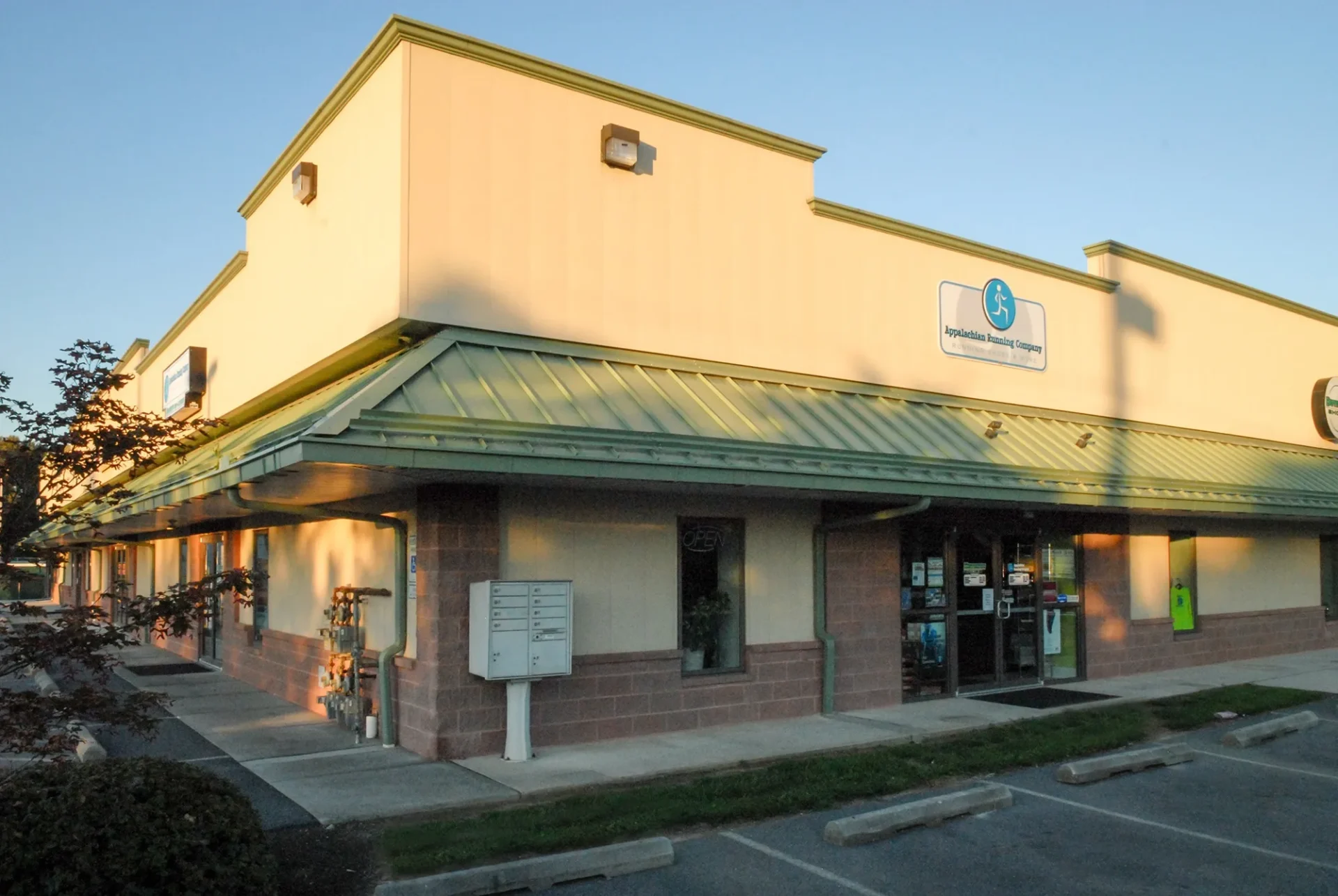 Exterior of a commercial building with signage at sunset