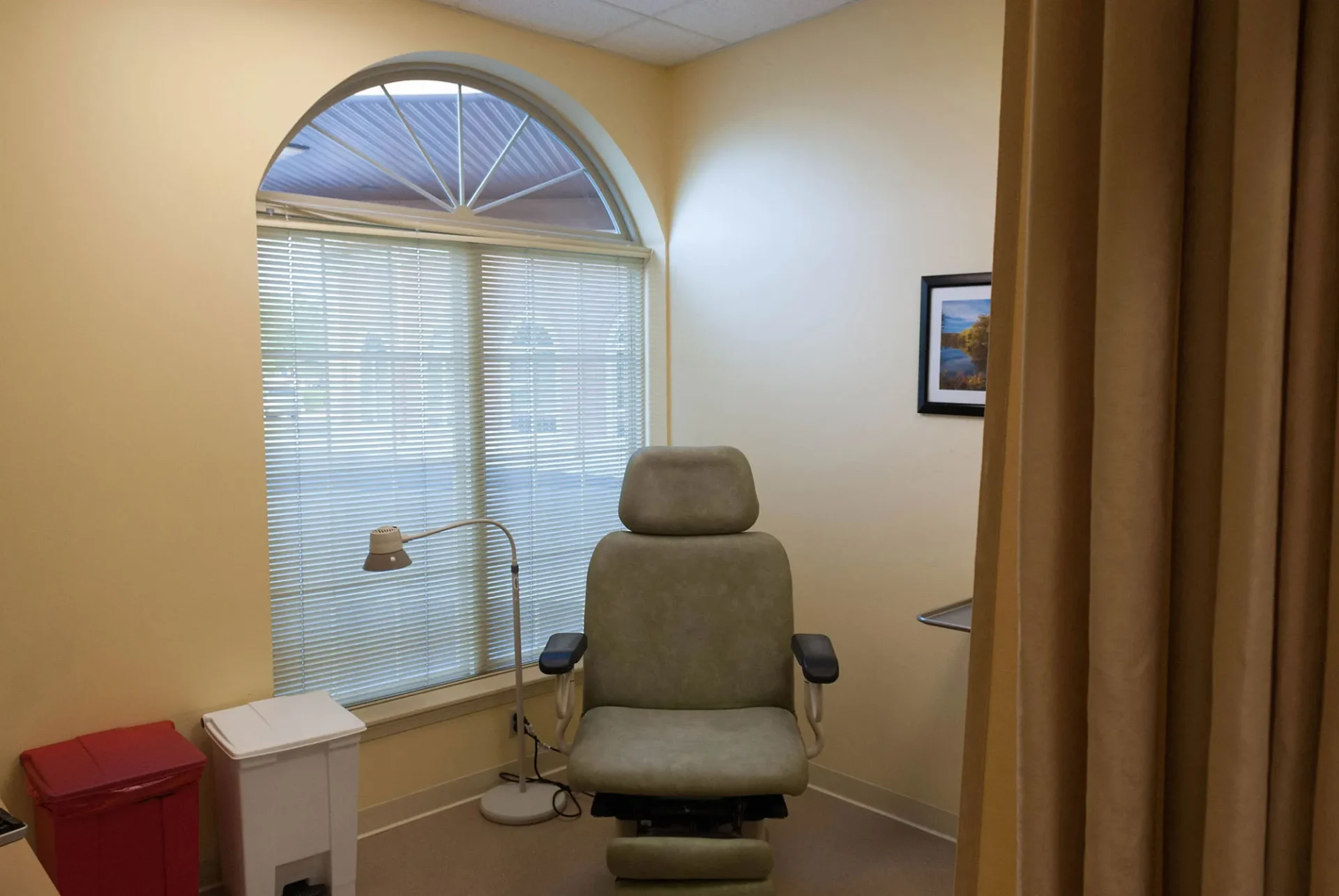 Contractor-for-Medical-Office-in-PA-Galbraith A medical office with a chair, floor lamp, window with blinds, and a framed picture