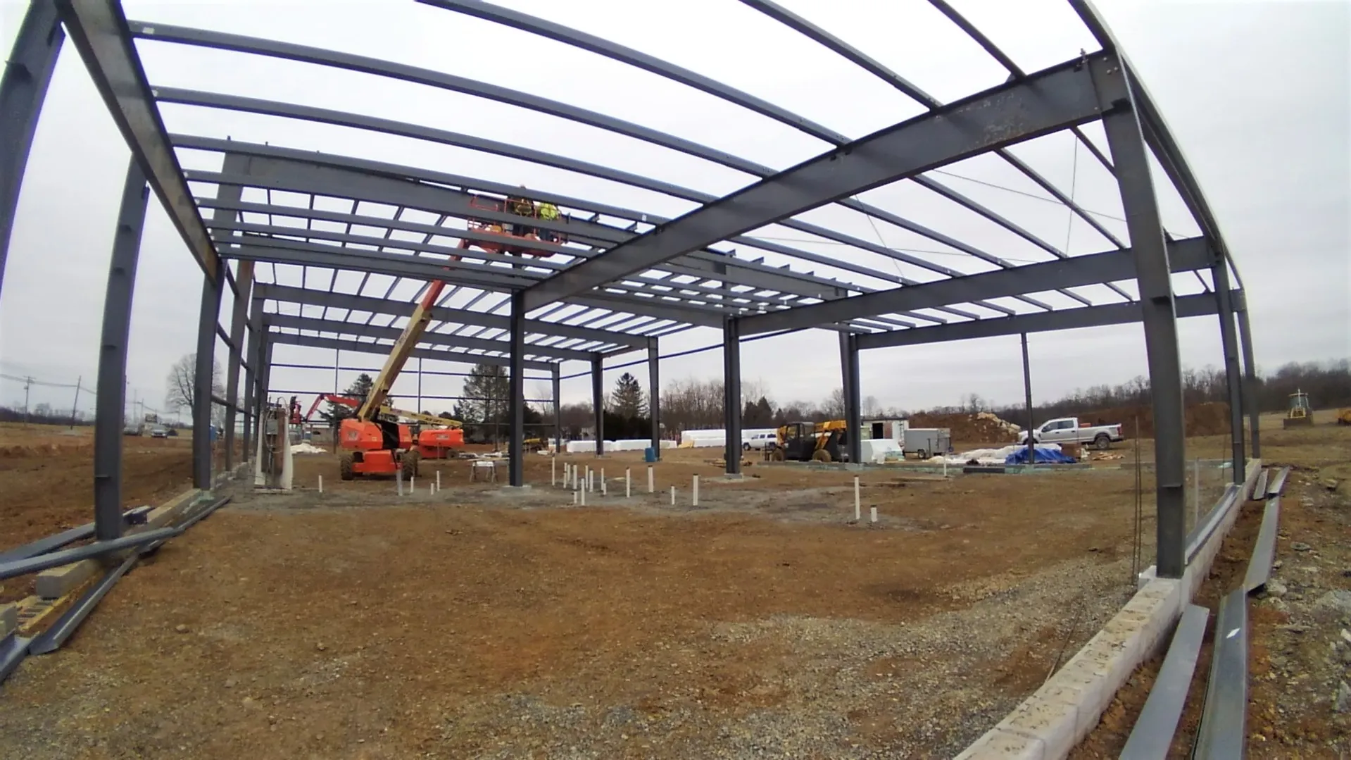 KIMG1299 Construction site with steel structure framework and heavy machinery